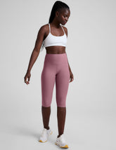 pink high-waisted pedal pusher length leggings.