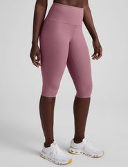 pink high-waisted pedal pusher length leggings.