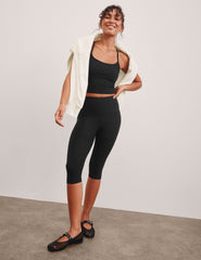 black high-waisted pedal pusher length leggings.
