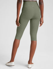 green high-waisted pedal pusher length leggings.