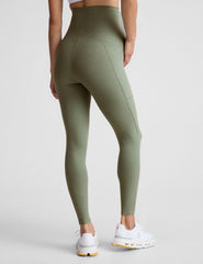 green high-waisted maternity leggings with pockets.
