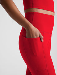 red high-waisted midi leggings with side pockets.