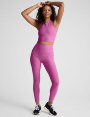 pink high-waisted midi length leggings with side pockets.