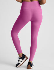 pink high-waisted midi length leggings with side pockets.