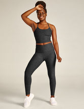 black-charcoal high-waisted midi legging with a crossover detail on the front waistband.