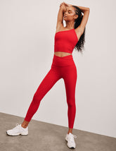 red high-waisted midi legging with criss cross front detail.