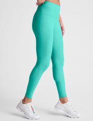 blue high-waisted midi length leggings with a crossover detail on the front waistband.