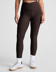 brown high-waisted midi length leggings with an overlapping front waistband.