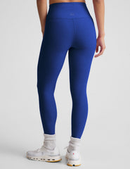 blue high-waisted midi leggings with a crossover detail on the front waistband.
