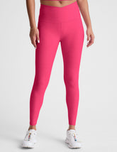 pink high-waisted midi length leggings with a crossover detail on the front waistband.