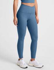 blue high-waisted midi length leggings with an overlapping front v waistband.