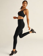 black high-waisted leggings with side pockets. midi length, stops right above ankle.