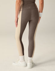 brown high-waisted midi leggings with eggshell outline details on the sides.
