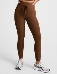 brown high-waisted midi length leggings with a drawstring at waistband and side pockets.