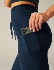 blue high-waisted midi leggings with a drawstring at waistband and side pockets.