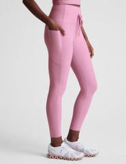 pink high-waisted midi length leggings with a drawstring at the waist and side pockets.