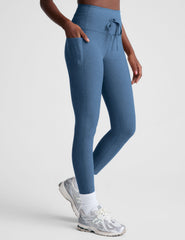 blue high-waisted midi leggings with pockets and a drawstring at waistband.