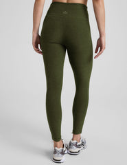 green high-waisted midi length leggings with white piping along sides.