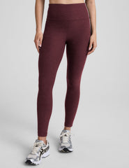 red high-waisted midi length leggings with white piping along sides.