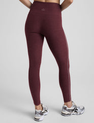 burgundy leggings with a white stripe on a gray background.