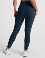blue high-waisted midi length leggings with white piping on the side.