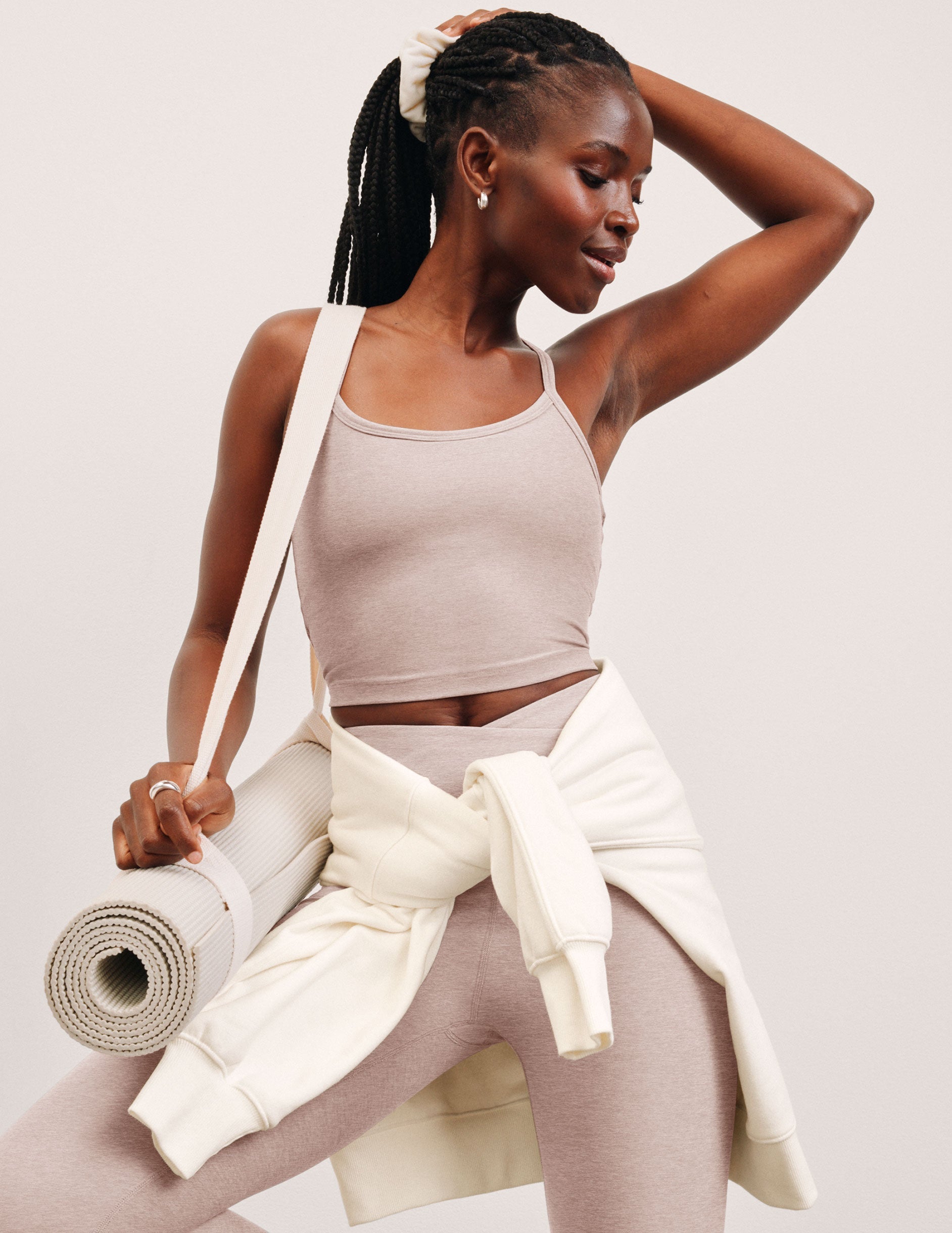 pink slim racerback cropped tank top and pink high-waisted midi leggings.