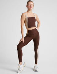 brown square neck cropped tank with white straps and white outlining down the sides.