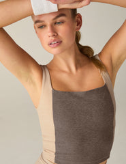 brown square neck cropped tank top with white lining on the sides.