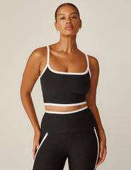 black cropped tank with white lining along neckline and waistline.