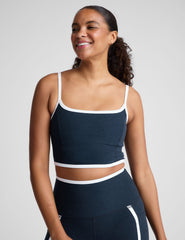 blue cropped tank with princess seams and white piping along edges.