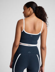 blue cropped tank with princess seams and white piping along edges.