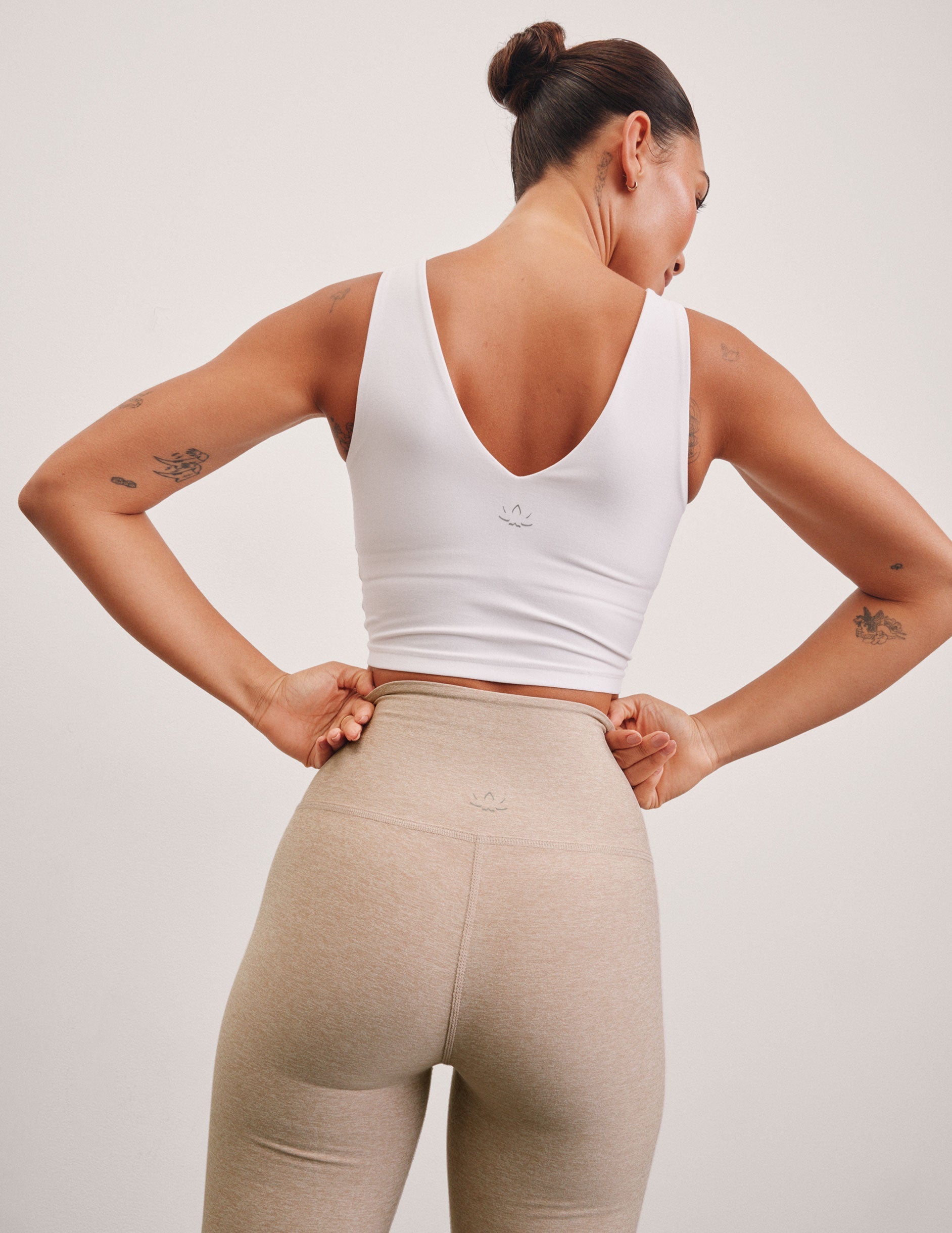 white cropped tank with a front and back v neckline.