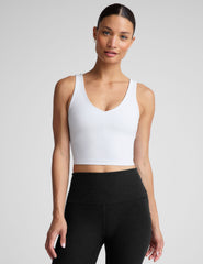 white cropped tank with a front and back v neckline.