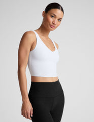 white cropped tank with a front and back v neckline.