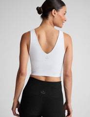 white cropped tank with a front and back v neckline.