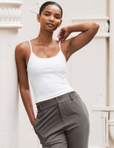 white midway length tank with adjustable spaghetti straps.