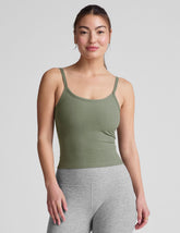 green waist length tank top with adjustable straps.