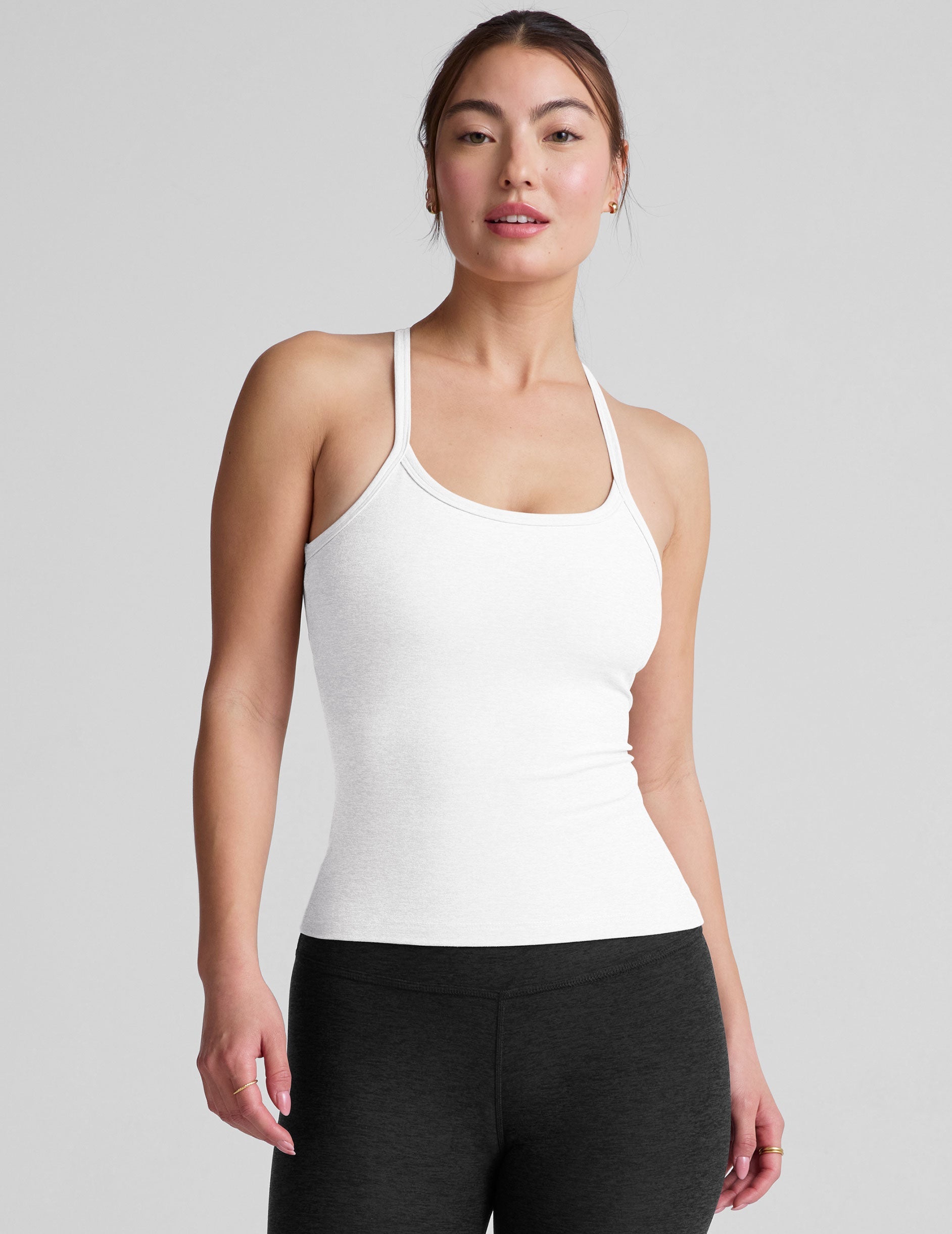 white midway length tank with adjustable spaghetti straps.