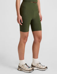 model is wearing green high-waisted 7" inseam biker shorts.