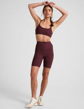 model is wearing red high-waisted 7" inseam biker shorts.