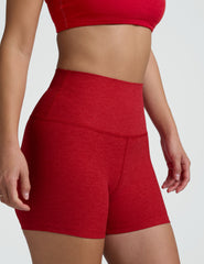 woman wearing red 3" inseam biker shorts against a plain background.