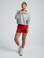 woman wearing red 3" inseam biker shorts against a plain background.