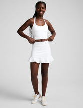 white skirt with a ruffle hem and built-in shorts with pockets.