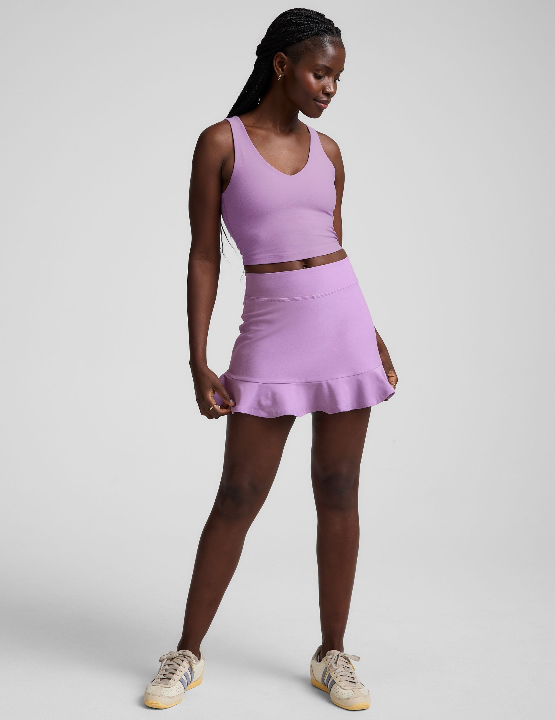 purple high-waisted skirt with a ruffle hem and built-in shorts with pockets.