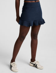 blue high-waisted skirt with a ruffle hem and built-in shorts with pockets.
