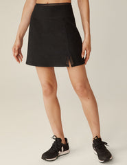 black mini skirt with a lace trim waistband and a small front slit with lace trim.