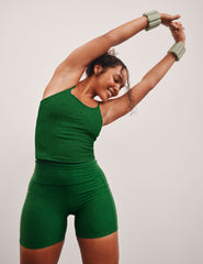 green high-waisted biker shorts with a 5" inseam and side pockets.