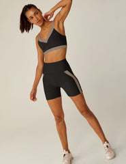 black high-waisted biker shorts with brown lining down the sides.