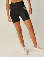black high-waisted biker shorts with brown lining down the sides.