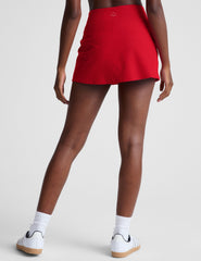 red mini skirt with built-in shorts and a front side slit.